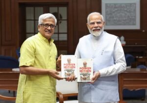 Pm signs copy of Dr R Balasubrahmanyam's book 'Power In: The Leadership Legacy of Narendra Modi